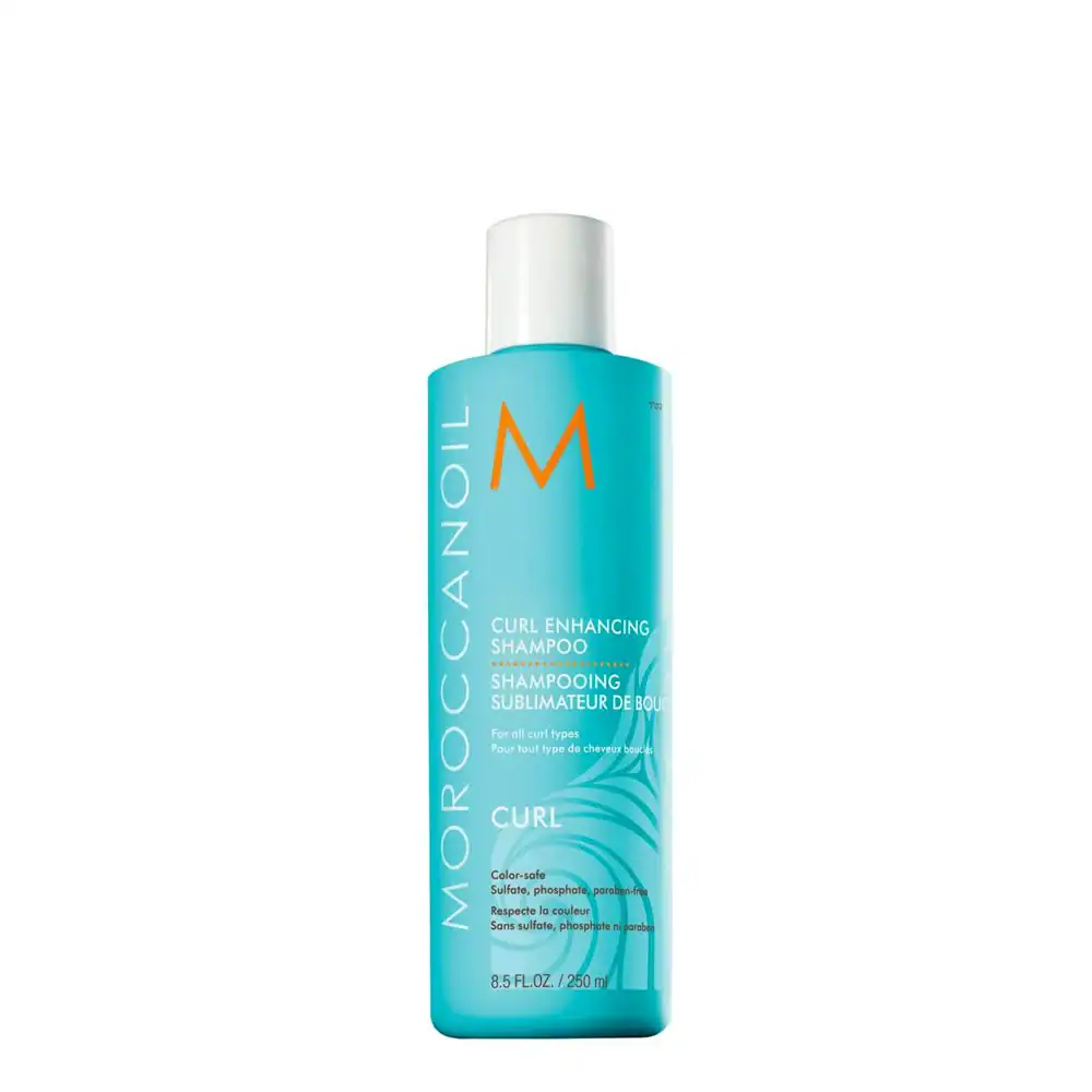 Shampoing Moroccanoil pour cheveux bouclés, bouteille bleue avec logo orange.